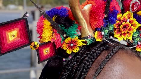 Beautiful-folkloric-headdress-made-with-pompoms,-yarn-and-bead-flowers