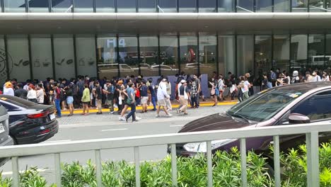 Long-line-up-of-people-auditioning-outside-a-mall