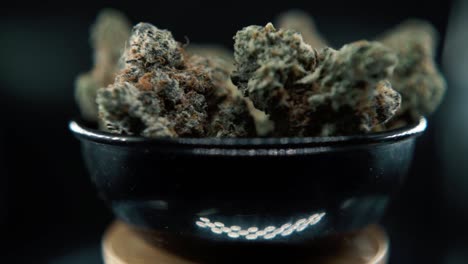 A-macro-detailed-STEADY-shot-of-a-cannabis-plant,-hybrid-orange-strains,-sativa-,marijuana-flower,-on-a-rotating-stand,-Full-HD,-super-slow-motion,-120-fps,-studio-lighting