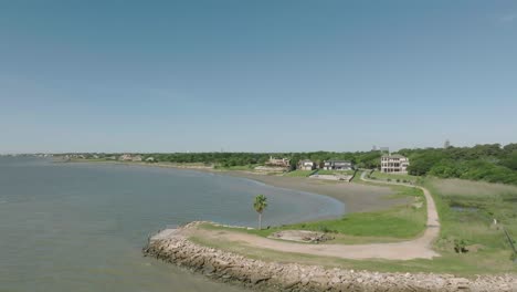 An-aerial-view-captures-waterfront-properties-and-homes-on-a-clear,-sunny-morning-with-blue-skies-over-Galveston-Bay-in-Seabrook,-Texas