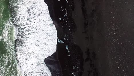 Drone-shot-of-dramatic-landscape-of-Icelandic-Black-Sand-Beach-Reynisfjara-near-town-Vik