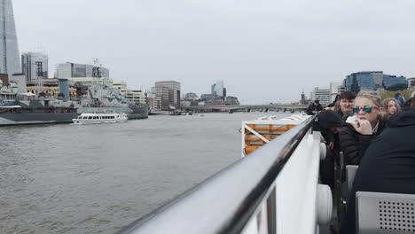 View-Of-Thames-river-boat-railing-with-tourists-on-top-deck-docked-at-Tower-Millennium-Pier