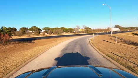 Car-driving-through-a-rest-area-in-Kerrville,-Texas,-USA,-POV-wide-shot