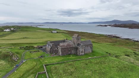 Iona,-Scotland-UK,-Aerial-View-of-Iona-Abbey-and-Nunnery-Museum,-Medieval-Building-on-Isle-of-Mull,-Drone-Shot-60fps