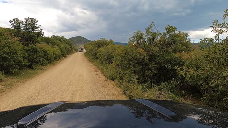 Camión-Maderero-Pasando-Mientras-Conduce-Por-Un-Camino-De-Tierra,-Toma-Pov