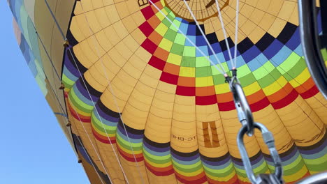 POV-of-Passanger-Riding-On-Rainbow-Hot-Air-Balloons,-Close-Up-To-Inside-of-Balloon-Parachute