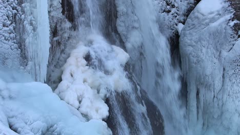 Beautiful-ice-formation-on-rock-at-Helgufoss-waterfal,-Southern-Iceland