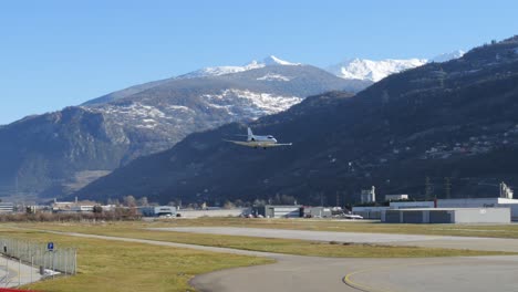 Private-Jet-Airplane-Lands-at-Mountain-Airport---Sunny-Day---Track