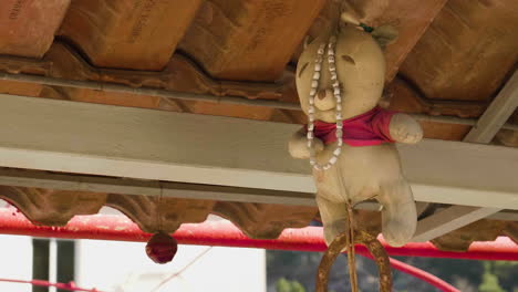 Symbols-of-Good-Luck-Hanging-Outside-House,-Dordolec,-Albania,-Zooming-out