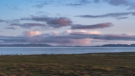 Greyish-clouds-lit-pink-by-the-setting-sun-above-the-Vardo-fjord-and-autumn-tundra