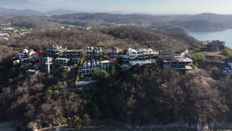 Aerial-view-of-houses-perched-on-hills-in-Huatulco,-Oaxaca,-Mexico