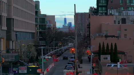 An-aerial-view-of-the-World-Trade-Center-in-the-distance-between-buildings-over-a-street-in-Coney-Island-Brooklyn-on-a-cloudy-morning