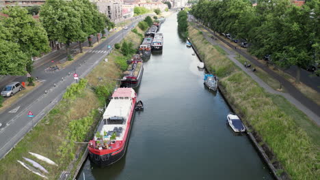 Upward-Tilt-Aerial-Reveals-the-City-of-Ghent-with-Canals,-Bridges-and-Houses