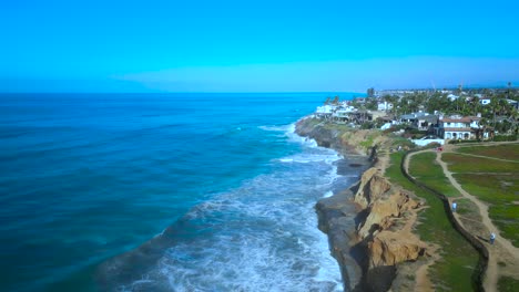 Drone-Shot-of-the-Carlsbad-Coastline-on-a-beautiful-sunny-day-with-cliff-and-waves
