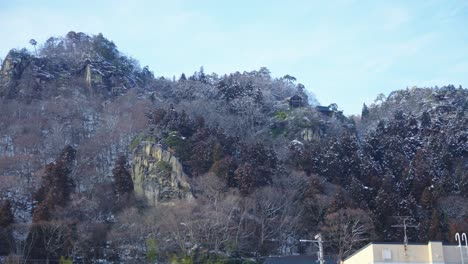 Snowy-Mountain-of-Yamadera-with-Temple-in-Japanese-Countryside,-Winter-View