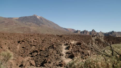 Volcanic-lava-field-with-Mount-Pico-del-Teide-and-Los-Roques-de-Garcia,-Teide-National-Park-in-Tenerife,-Canary-Islands-in-spring