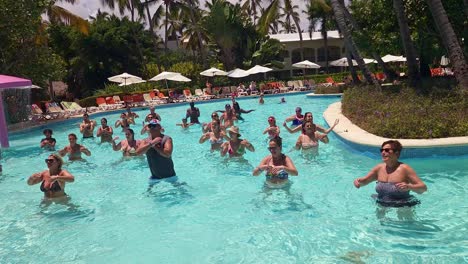 Resort-guests-doing-water-aerobics-at-Impressive-Resort-and-and-Spa-in-Punta-Cana,-Dominican-Republlic