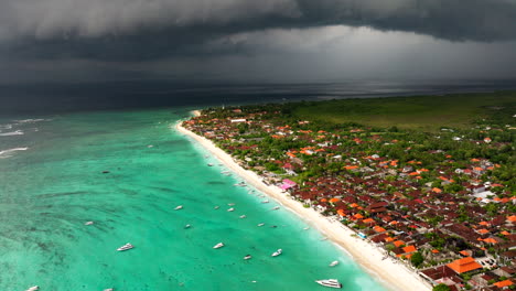 Stormy-dark-ominous-clouds-over-turquoise-ocean-water-and-beach-of-Nusa-Lembongan-in-Indonesia