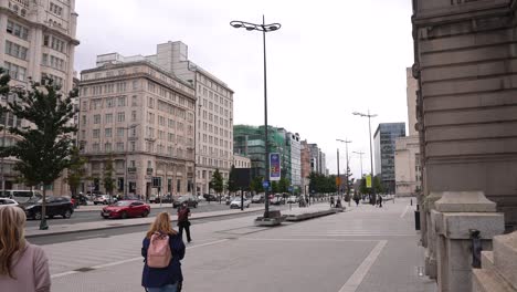 Liverpool,-England-UK,-People-Walking-on-Pavement-Between-Downtown-Buildings-on-Cloudy-Day