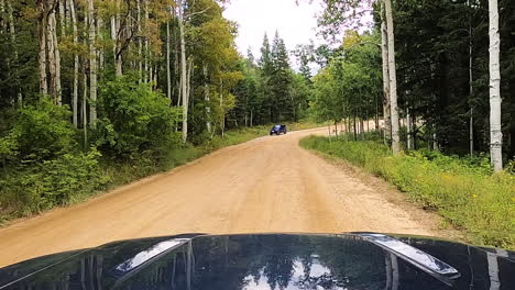 Passing-by-couple-SUV's-in-dirt-forest-road,-car-POV-shot