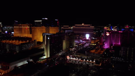 Las-Vegas-at-Night,-Aerial-View-of-Casino-Hotels-on-Strip,-Illumination-on-Buildings-and-Streets
