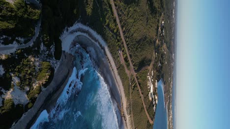 Vertical-drone-shot-of-Blue-Heaven-Beach-with-green-coastline-and-bay-in-Western-Australia