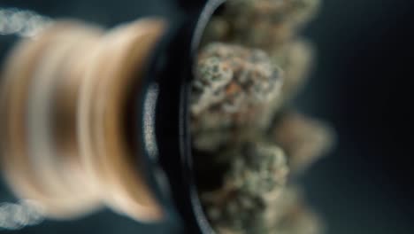 A-vertical-macro-smooth-detailed-shot-of-a-cannabis-plant,-hybrid-orange-strains,-sativa-,marijuana-flower,-on-a-rotating-stand,-Full-HD,-super-slow-motion,-120-fps,-studio-lighting