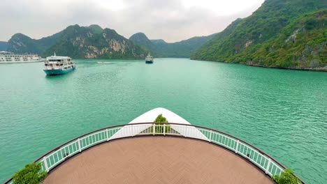 Symmetrical-view-from-bow-of-cruise-ship-out-to-Ha-Long-Bay-and-Lan-Ha-Bay-heritage-area-in-Vietnam