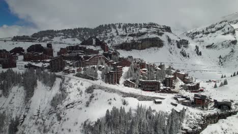 French-Alpine-ski-village-in-the-winter,-4K-aerial