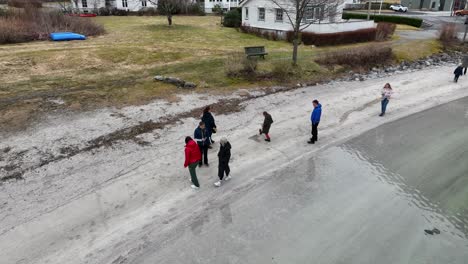 Tourists-walking-on-local-beach-during-sightseeing-trip-at-springtime