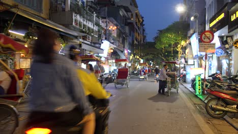 Traditional-Vietnamese-Cyclos-and-motorcycles,-city-night-street-scene