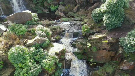 Aerial-drone-footage-of-a-tall-rocky-waterfall-in-the-Yorkshire-Dales,-Pennies