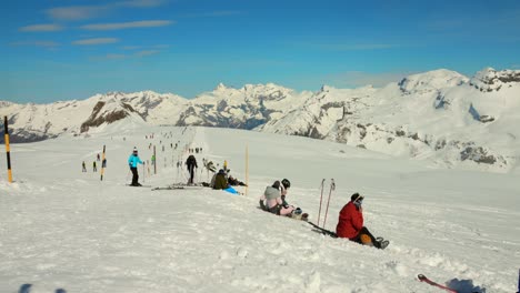 Beautiful-sunny-day-at-Ski-resort,-people-slopes-French-Alps