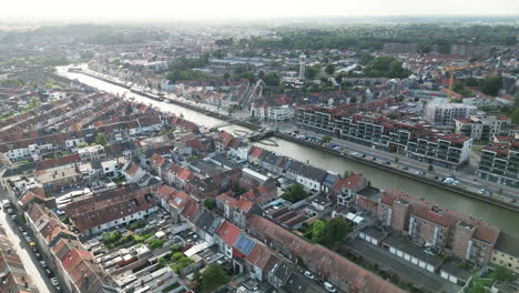 Wide-Aerial-over-Wondelgemstraat-Neighborhood-in-Ghent-City-with-Canals,-Traffic-and-Houses