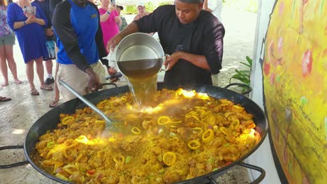 Chef-adds-Chicken-stock-to-Papaya-during-cooking-class-at-Impressive-Resort-and-Spa-in-Punta-Cana,-Dominican-Republic