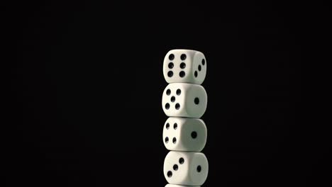 Moving-close-up-shot-of-a-stack-of-dices,-with-black-background