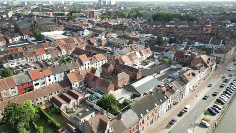 Aerial-View-of-Canal-and-Traffic-Flowing-Through-Ghent-City-Reveals-the-Historical-City-Center