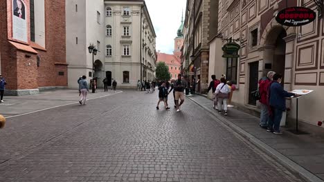 Warsaw,-Poland,-a-lively-pedestrian-zone-bustles-with-people-strolling-along-the-vibrant-streets,-embodying-the-idea-of-leisurely-travel-and-free-time