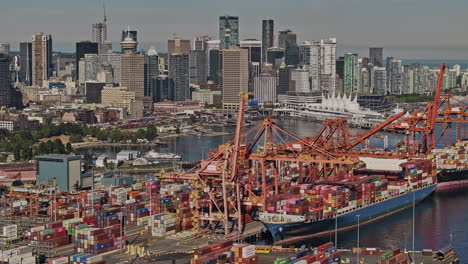 Vancouver-BC-Canada-Aerial-v95-zoomed-shot-drone-flyover-the-harbour-capturing-industrial-shipyard,-ferry-terminal-and-waterfront-downtown-cityscape---Shot-with-Mavic-3-Pro-Cine---July-2023