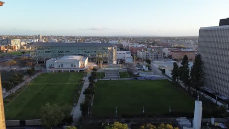 Push-in-drone-shot-of-dense-urban-city-neighborhood-during-sunset