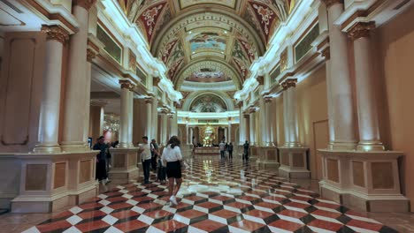 Interior-of-ornate-hotel-lobby-with-travelers-at-the-Venetian-Resort,-Las-Vegas