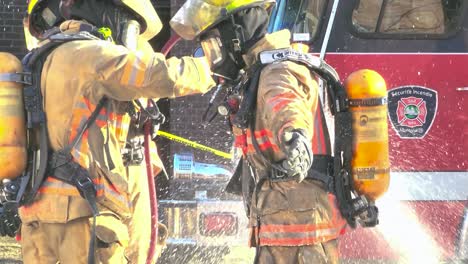 Firefighters-hosing-down-after-an-abandoned-building-fire-in-Montreal,-Quebec,-Canada,-daytime