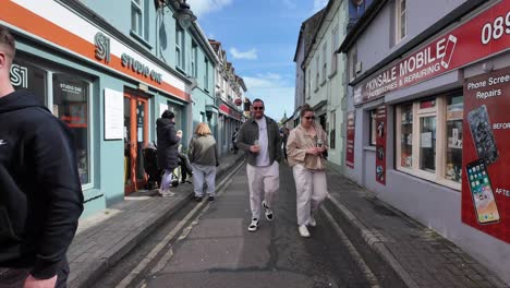 Street-food-festival-yearly-event-with-crowds,-people-walking,-sitting,-talking-in-Kinsale,-Ireland-on-a-sunny-day