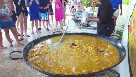 Chef-adds-shrimp-and-muscles-to-Papya-dish-during-cooking-class-att-Punta-Cana,-Dominican-Republic