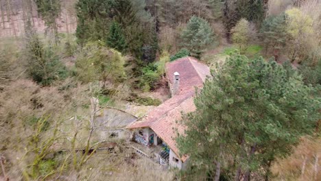 Aerial-view-above-abandoned-mansion-property-in-the-belgian-rural-forest