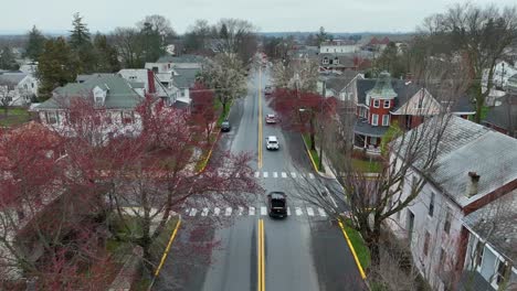 Aerial-approaching-shot-of-american-small-town-with-colorful-trees-in-spring