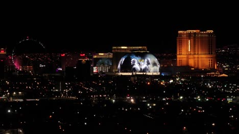 Las-Vegas-Nevada-USA,-Drone-Shot-of-Sphere-at-Night,-Strip-Hotels-and-Casinos-and-Roller-Ferris-Wheel