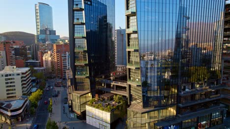 Aerial-ascending-shot-of-Modern-glass-MUT-tower,-Touristic-place-in-Santiago-Downtown,-Chile