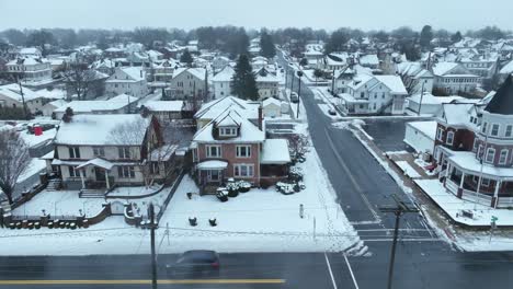 Corner-view-of-snowy-town-with-Victorian-homes-and-clear-roads