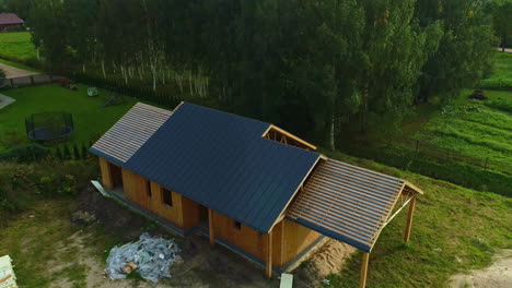 Wooden-frame-house-building-lodge-forest-woods-under-construction